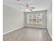 Bright bedroom with wood-look flooring, a ceiling fan, and a large window at 4940 Windsor Green Way # 203, Myrtle Beach, SC 29579
