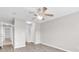 Bright bedroom with hardwood floors, neutral paint, a ceiling fan, and access to closets and the ensuite at 4940 Windsor Green Way # 203, Myrtle Beach, SC 29579