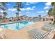 Inviting community pool area with lounge chairs, mature landscaping, and well-maintained pool at 4940 Windsor Green Way # 203, Myrtle Beach, SC 29579