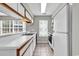 Well-lit kitchen with white cabinets, long countertop, and stainless-steel appliances at 4940 Windsor Green Way # 203, Myrtle Beach, SC 29579