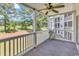 Covered patio overlooking the mature golf course featuring white railings and neutral colored carpeting at 4940 Windsor Green Way # 203, Myrtle Beach, SC 29579