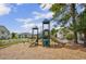 Playground with slides and climbing structures, set in a fenced area with mature trees at 4940 Windsor Green Way # 203, Myrtle Beach, SC 29579