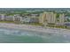 An aerial view showcases a luxurious hotel on the beach, complete with a spacious sandy beach for sunbathing at 501 S Ocean Blvd. # 307, North Myrtle Beach, SC 29582