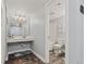Bright bathroom features a vanity with decorative mirror and separate toilet and shower area at 501 S Ocean Blvd. # 307, North Myrtle Beach, SC 29582