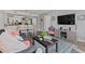 Cozy open-concept living space features wood-look flooring, a tv, and a dining area adjacent to the kitchen at 501 S Ocean Blvd. # 307, North Myrtle Beach, SC 29582
