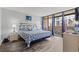 Comfortable main bedroom with balcony access, wood floors, and tasteful decor at 501 S Ocean Blvd. # 307, North Myrtle Beach, SC 29582