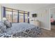 Serene main bedroom with balcony access, wood floors, and charming coastal decor at 501 S Ocean Blvd. # 307, North Myrtle Beach, SC 29582