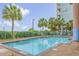 Outdoor swimming pool surrounded by palm trees, offering a refreshing leisure space at 501 S Ocean Blvd. # 307, North Myrtle Beach, SC 29582