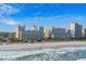 Scenic aerial view of beachfront condos overlooking the shoreline with blue skies and crashing waves at 5200 N Ocean Blvd. # 937, Myrtle Beach, SC 29577