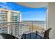 Balcony with a view of the ocean, beach, and adjacent high rise with seating for three at 5200 N Ocean Blvd. # 937, Myrtle Beach, SC 29577