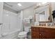 Well-lit bathroom with a shower-tub combo, wood vanity, large mirror, and fresh towels at 5200 N Ocean Blvd. # 937, Myrtle Beach, SC 29577