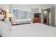 Bright bedroom with two beds, balcony access, a dresser with a TV, and a full-length mirror at 5200 N Ocean Blvd. # 937, Myrtle Beach, SC 29577