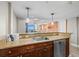 Modern kitchen with stainless steel dishwasher and bar top that opens to the living room and ocean view at 5200 N Ocean Blvd. # 937, Myrtle Beach, SC 29577