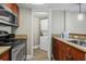 Efficient kitchen with stainless appliances, granite countertops and view of the laundry behind a folding door at 5200 N Ocean Blvd. # 937, Myrtle Beach, SC 29577