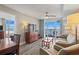 Cozy living room features balcony access with ocean views, comfortable seating, and a dining area nearby at 5200 N Ocean Blvd. # 937, Myrtle Beach, SC 29577