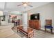 Bright living room opens to the kitchen and dining area, with modern furnishings, a large TV, and wood floors at 5200 N Ocean Blvd. # 937, Myrtle Beach, SC 29577