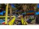 Exterior view of a vibrant restaurant with colorful seating and lush greenery and palm trees at 539 Slaty Dr., Myrtle Beach, SC 29588