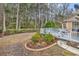This backyard features a deck, a wooded border, and manicured landscaping at 540 Alderly Ct., Little River, SC 29566