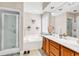 Well-lit bathroom featuring a glass shower, soaking tub, and double sink vanity at 540 Alderly Ct., Little River, SC 29566