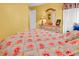 Comfortable bedroom with bright yellow walls, floral bedding and soft natural light at 540 Alderly Ct., Little River, SC 29566