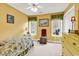 Cozy bedroom with bright yellow walls, floral bedding, and natural light from large windows at 540 Alderly Ct., Little River, SC 29566