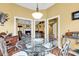 Bright dining room with a glass table, elegant chairs, and open access to other rooms at 540 Alderly Ct., Little River, SC 29566