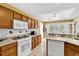 Bright kitchen with updated appliances, wood cabinets and a view to the breakfast nook at 540 Alderly Ct., Little River, SC 29566