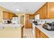 Spacious kitchen featuring wood cabinets, a breakfast bar, and modern appliances at 540 Alderly Ct., Little River, SC 29566