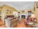 Cozy living room featuring a fireplace, ceiling fan, and hardwood floors at 540 Alderly Ct., Little River, SC 29566