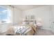 Well-lit bedroom featuring a large window, neutral colors, and comfortable furnishings at 559 Firouz Dr, Longs, SC 29568
