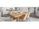Open-concept kitchen/dining area with modern table, chairs, and view of the living area at 559 Firouz Dr, Longs, SC 29568