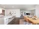 Open concept kitchen and dining area with granite countertops, seating, and natural light at 559 Firouz Dr, Longs, SC 29568