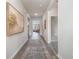 Inviting hallway with wood floors, neutral walls, and stylish decor, leading to living areas at 559 Firouz Dr, Longs, SC 29568