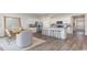 Bright kitchen features white cabinets, stainless steel appliances, and an island with barstool seating at 559 Firouz Dr, Longs, SC 29568