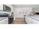 Spacious kitchen featuring stainless steel appliances and granite countertops and white cabinetry at 559 Firouz Dr, Longs, SC 29568