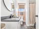 Modern bathroom with a granite countertop, framed mirror, and patterned shower curtain at 6001 - T33 South Kings Hwy., Myrtle Beach, SC 29575