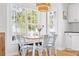 Cozy breakfast nook offers natural light, modern decor, and views of the home's exterior at 6001 - T33 South Kings Hwy., Myrtle Beach, SC 29575
