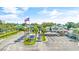 Scenic entrance of a community featuring a water fountain, American flag, palm trees, and blue skies at 6001 - T33 South Kings Hwy., Myrtle Beach, SC 29575