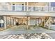 Open-air ground floor featuring a grilling area, dining space, and garage access at 6001 - T33 South Kings Hwy., Myrtle Beach, SC 29575