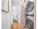 Hallway with a stacked washer and dryer and a view into a bathroom with black tile at 6001 - T33 South Kings Hwy., Myrtle Beach, SC 29575