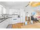 Open-concept kitchen and breakfast nook feature white cabinets, stainless appliances, and hardwood floors at 6001 - T33 South Kings Hwy., Myrtle Beach, SC 29575