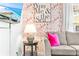 Close up shot of the living room featuring flamingo wallpaper, modern decor, and a grey sofa with pink pillows at 6001 - T33 South Kings Hwy., Myrtle Beach, SC 29575