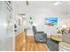Bright living room features hardwood floors, a modern recliner, and views into other areas of the home at 6001 - T33 South Kings Hwy., Myrtle Beach, SC 29575