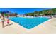Outdoor pool area with lounge chairs, clear blue water, and people enjoying the sunny day at 6001 - T33 South Kings Hwy., Myrtle Beach, SC 29575