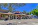 Exterior shot of a small mart with a variety of golf carts parked out front on a clear, sunny day at 6001 - T33 South Kings Hwy., Myrtle Beach, SC 29575