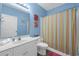 Bright bathroom featuring a vanity and colorful shower curtain at 601 N Hillside Dr. # 2235, North Myrtle Beach, SC 29582