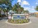 Community entrance sign, featuring brick pillars, landscaping, and a view of the lake at 601 N Hillside Dr. # 2235, North Myrtle Beach, SC 29582