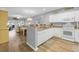 Open-concept kitchen flows into the dining area with modern appliances and light wood floors at 601 N Hillside Dr. # 2235, North Myrtle Beach, SC 29582
