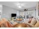 Bright living room with a striped sofa, coastal decor, and sliding glass doors to the balcony at 601 N Hillside Dr. # 2235, North Myrtle Beach, SC 29582