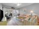 Comfortable living room featuring a sofa, wicker chairs, and sliding doors to a balcony at 601 N Hillside Dr. # 2235, North Myrtle Beach, SC 29582